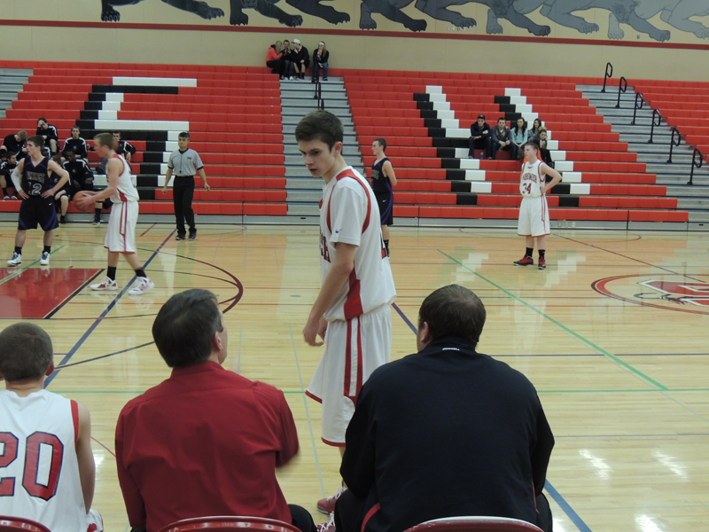 Sophomore Zack Carlson gets instructions from Coach Riedeman during a free throw